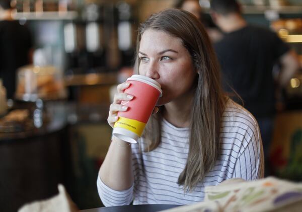 Dani Hermoza, from Smyrna, tries a CBD latte at Rev Coffee in Smyrna. The coffee shop offers a CBD oil latte as well as the option to add it to any beverage. Cannabidiol oil products are gaining in popularity. Bob Andres / bandres@ajc.com