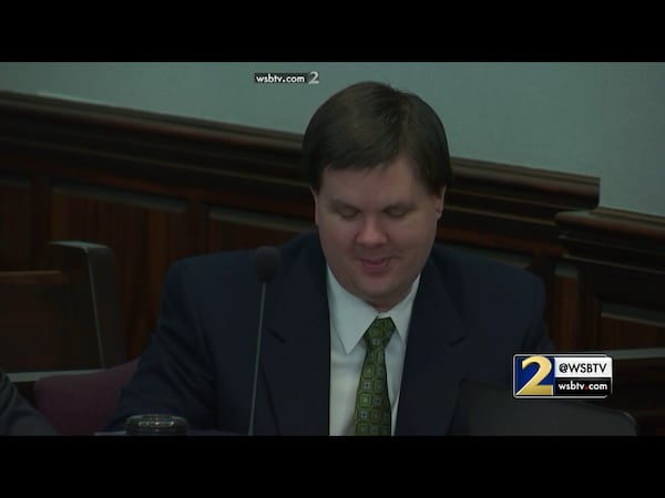 Justin Ross Harris cracks a smile while the jury sees family photos of baby Cooper helping carve a pumpkin. The defense was showing dozens of family photos while questioning Harris' ex-wife Leanna Taylor during Harris' murder trial at the Glynn County Courthouse in Brunswick, Ga., on Monday, Oct. 31, 2016. (screen capture via WSB-TV)