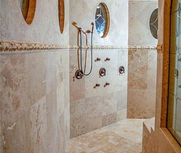 The walk-in shower of the primary bath at Tameka "Tiny" Cottle's McDonough mansion. BADON COMMERCIAL REAL ESTATE