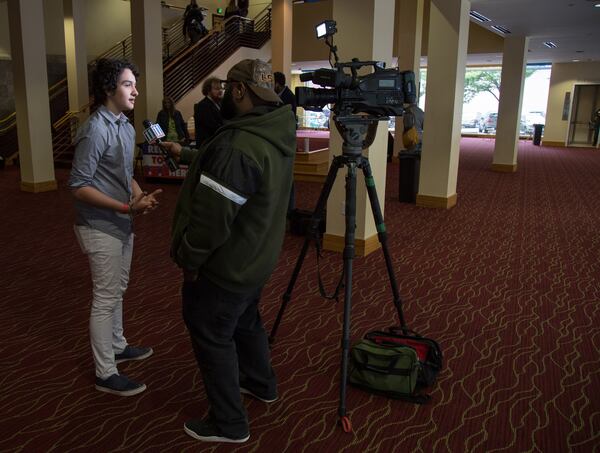 High school student and event organizer Royce Mann is interviewed in the lobby of the Rialto Center for the Arts before the start of the Town Hall For Our Lives Atlanta Saturday, April 7, 2018. Another metro Atlanta town hall was held earlier in the day in Conyers and included invited speaker U.S. Rep. Hank Johnson. Students organized the town halls across the nation on Saturday to spotlight gun violence and school safety.  STEVE SCHAEFER / SPECIAL TO THE AJC