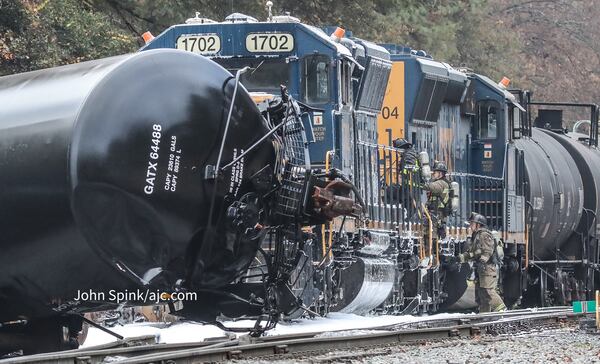 Atlanta fire crews work to extinguish a locomotive fire after eight train cars derailed Friday morning.