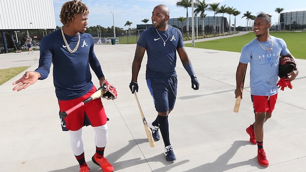 Braves Ronald Acuna (from left), Marcell Ozuna and Ozzie Albies walk back to the training facility after finishing up some morning batting practice during spring training Sunday, Feb. 16, 2020, in North Port, Fla. It's the first day in camp for Ozuna, who joined the Braves on a one year, 18 million deal.