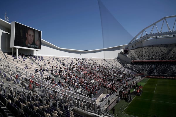 Friends, family and soccer fans attend a public memorial ceremony for slain hostage Tsachi Idan, a fan of Hapoel Tel Aviv F.C., who was killed in Hamas captivity in the Gaza Strip, at Bloomfield Stadium in Tel Aviv, Israel, Friday, Feb. 28, 2025. (AP Photo/Leo Correa)