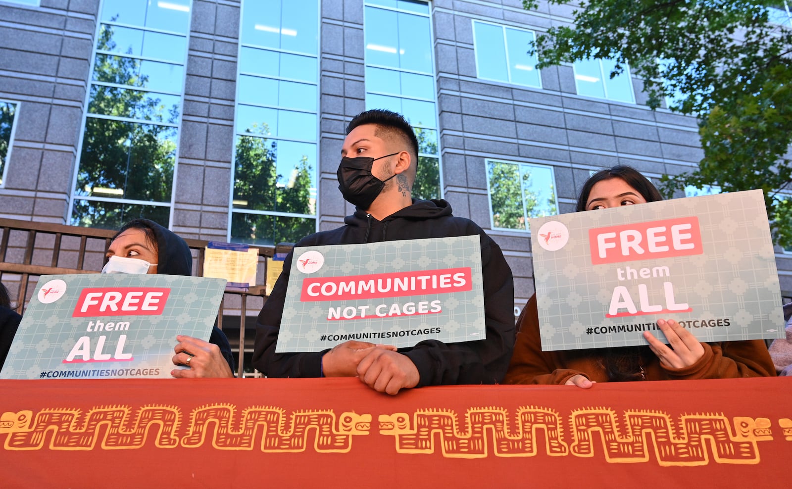 September 23, 2021 Atlanta - Protesters hold a sign during a rally to demand Biden to shut down detention centers, free immigrant detainees and stop deportations outside ICE Atlanta Field Office on Thursday, September 23, 2021. (Hyosub Shin / Hyosub.Shin@ajc.com)