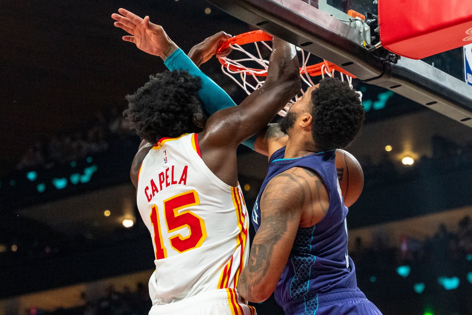 Atlanta Hawks center Clint Capela (15) slam-dunks over Charlotte Hornets forward Miles Bridges, right, during the first half of an NBA basketball game, Friday, Oct. 25, 2024, in Atlanta. (AP Photo/Jason Allen)