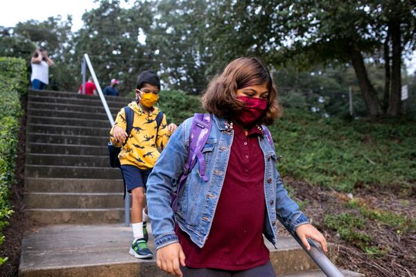 Dahlia and Omar Varghese walk to Burgess Elementary School in East Atlanta on Thursday, September 9, 2021. Serene Varghese’s daughter, Dahlia, got Covid-19 during the first week of school about a month ago. (Rebecca Wright for the Atlanta Journal-Constitution)