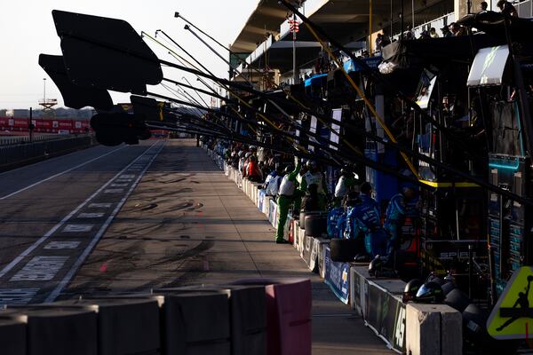 Team members line road as they await the finish for a NASCAR Cup Series auto race at Circuit of the Americas in Austin, Texas, Sunday, March 2, 2025. (AP Photo/Stephen Spillman)