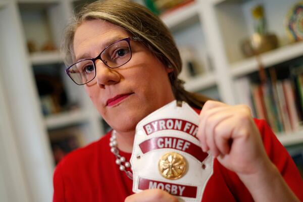 In this Sept. 26, 2019, file photo, former Byron, Ga., fire chief Rachel Mosby poses for a photo in the home of a friend in Atlanta. Mosby is a transgender woman who held the job for more than a decade as a man, then was fired in June, 18 months after she openly transitioned. (AP Photo/John Bazemore, File)