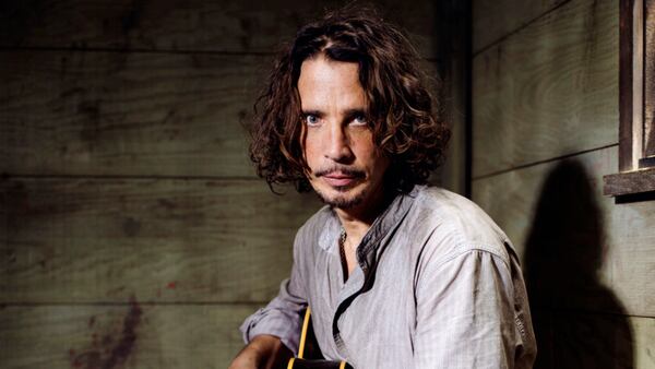 FILE - In this July 29, 2015 file photo, Chris Cornell plays guitar during a portrait session at The Paramount Ranch in Agoura Hills, Calif. Cornell, 52, who gained fame as the lead singer of the bands Soundgarden and Audioslave, died at a hotel in Detroit and police said Thursday, May 18, 2017, that his death is being investigated as a possible suicide. (Photo by Casey Curry/Invision/AP, File)