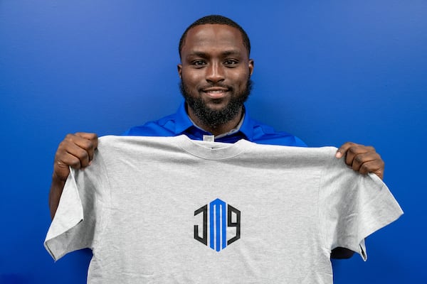 Georgia State linebacker Jamil Muhammad shows off the T-shirt he designed and sells.