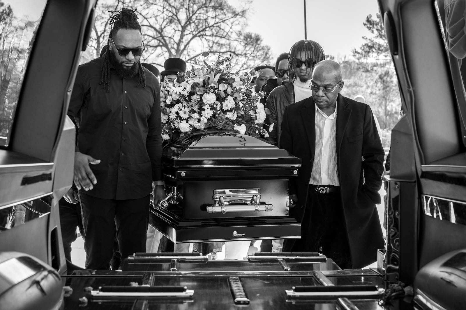 Pall bearers carry the casket of Julian Reeder into a hearse.