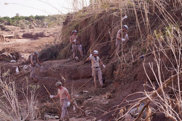 Soldiers from the Spanish Parachute Squadron (EZAPAC) look for bodies after floods in Barranco del Poyo, Spain, Tuesday, Nov. 5, 2024. (AP Photo/Alberto Saiz)