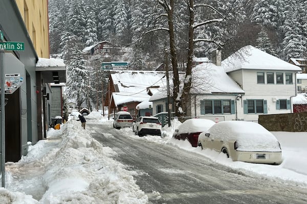 A man shovels snow in downtown Juneau, Alaska, on Monday, Dec. 2, 2024. (AP Photo/Becky Bohrer)