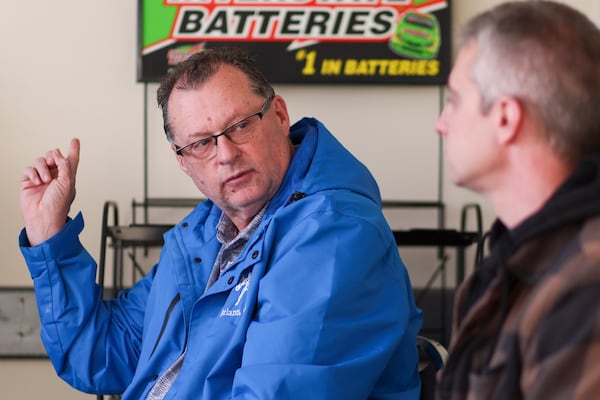 Larry Cox (left), vice president of a concrete-cutting company, and Jason Narde, owner of a manufacturing company near the BioLab site, discussed the Biolab fire at Greg Automotive on Wednesday, Dec. 11, 2024, in Conyers. (Jason Getz/AJC)
