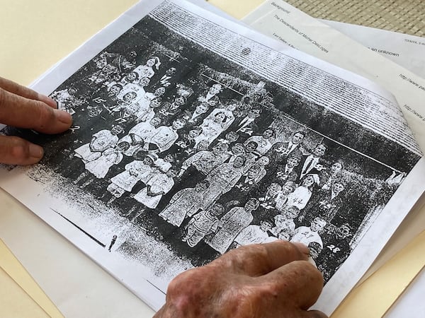 The Rewis family made up a large percentage of the Echols County population in the early 20th century. Austin DeLoach points out Rewises in this school photo from 1916. (Adam Van Brimmer/adam.vanbrimmer@ajc.com)