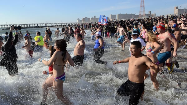 FILE PHOTO: Members of the Coney Island's Polar Bear Club take an icy dip on New Years Day just off the Boardwalk of Coney Island January 1, 2015 in the Brooklyn borough of New York City. (Photo by Astrid Riecken/Getty Images)