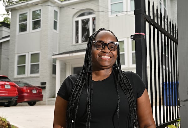 Robyn Mincey, resident, poses for a portrait outside the apartment complex owned by Atlanta-based real estate investment firm Roots, July 3, 2024, in Atlanta. Atlanta-based real estate investment firm Roots allows tenants in properties to invest their security deposit to help grow their savings and build credit. (Hyosub Shin / AJC)