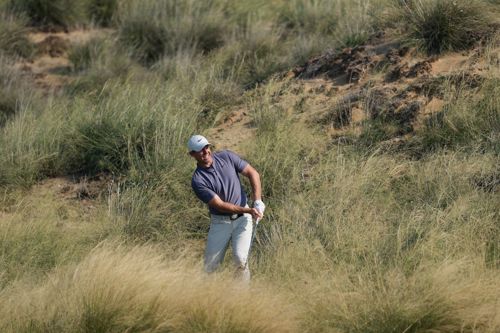 Rory McIlroy of Northern Ireland plays his second shot at the 13th hole during the second round of Abu Dhabi Golf Championship in Abu Dhabi, United Arab Emirates, Friday, Nov. 8, 2024. (AP Photo/Altaf Qadri)