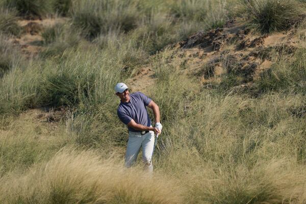 Rory McIlroy of Northern Ireland plays his second shot at the 13th hole during the second round of Abu Dhabi Golf Championship in Abu Dhabi, United Arab Emirates, Friday, Nov. 8, 2024. (AP Photo/Altaf Qadri)