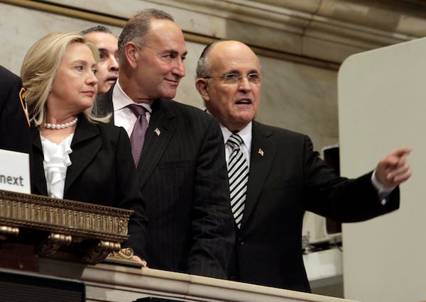 FILE - Then Secretary of State Hillary Rodham Clinton, U.S. Sen. Charles Schumer, center, and former New York Mayor Rudy Giuliani, participate in opening bell ceremonies of the New York Stock Exchange on Sept. 9, 2011, in commemoration of the 10th anniversary of the Sept. 11, 2001 attacks. (AP Photo/Richard Drew, File)