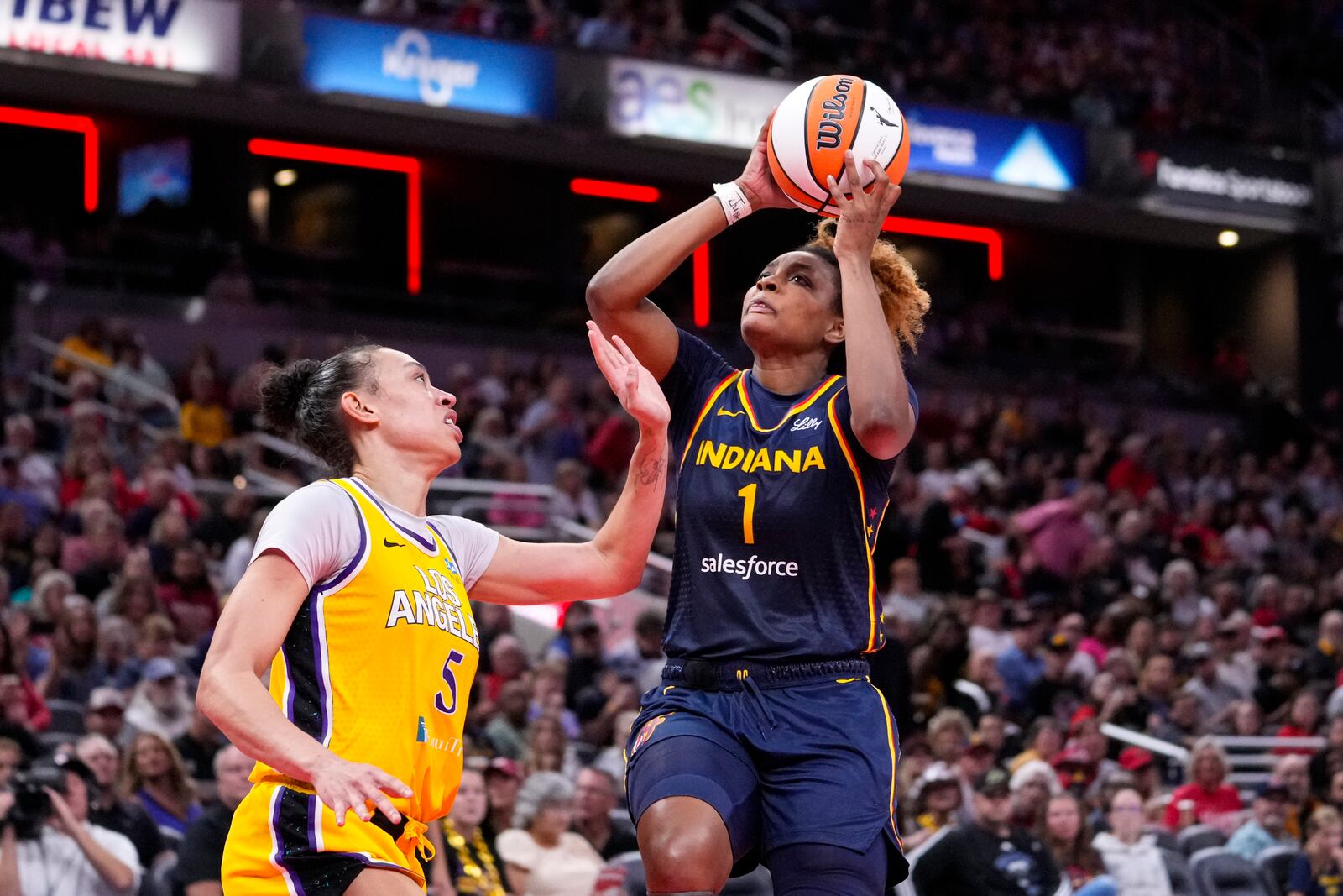 Indiana Fever forward NaLyssa Smith (1) shoots over Los Angeles Sparks forward Dearica Hamby (5) in the second half of a WNBA basketball game in Indianapolis, Wednesday, Sept. 4, 2024. (AP Photo/Michael Conroy)