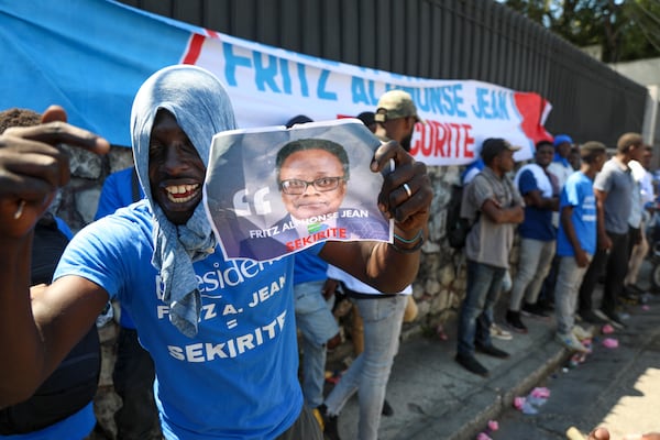 Supporters celebrate the installation of Fritz Alphonse Jean, an economist and former central bank governor, who replaces Leslie Voltaire in the rotating presidency of the transitional presidential council, in Port-au-Prince, Haiti, Friday, March 7, 2025. (AP Photo/Odelyn Joseph)