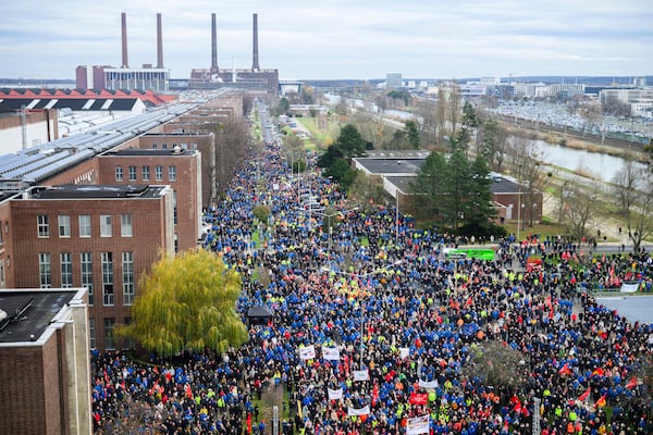 Volkswagen workers attend a rally during at nationwide warning Volkswagen workers' strike, on the grounds of the main Volkswagen plant in Wolfsburg, Germany, Monday, Dec. 2, 2024. (Julian Stratenschulte/dpa via AP)