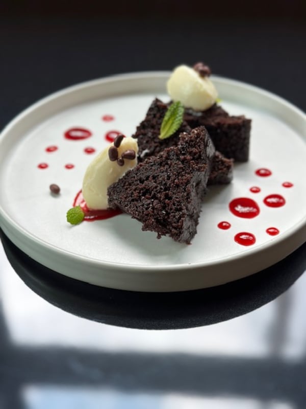 Raspberry beet sauce is an elegant enhancement to the moist chocolate cake with white chocolate cream cheese frosting at Southern National. Courtesy of Rebecca Carmen