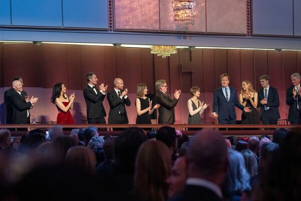 Comedian Conan O'Brien, fourth from right, is applauded as he takes his seat at the start of the 25th Annual Mark Twain Prize for American Humor Celebrating Conan O'Brien, Sunday, March 23, 2025, at the Kennedy Center for the Performing Arts in Washington. (AP Photo/Kevin Wolf)