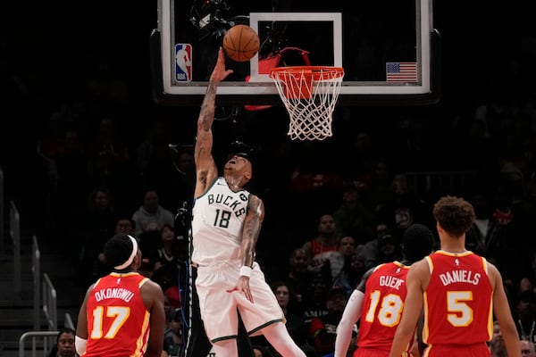 Milwaukee Bucks forward Kyle Kuzma (18) scores in the first half of an NBA basketball game against the Atlanta Hawks, Tuesday, March 4, 2025, in Atlanta. (AP Photo/Brynn Anderson)