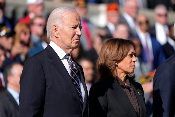 President Joe Biden, left, and Vice President Kamala Harris look on during a wreath laying ceremony at the Tomb of the Unknown Soldier on National Veterans Day Observance at Arlington National Cemetery in Arlington, Va., Monday, Nov. 11, 2024. (AP Photo/Mark Schiefelbein)