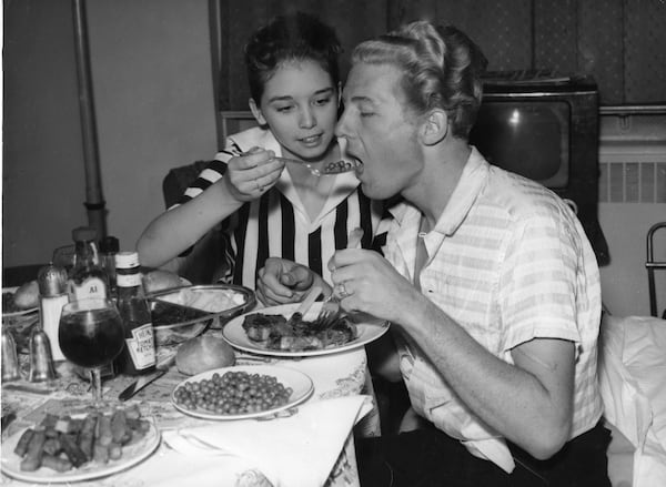 Jerry Lee Lewis and his 13-year-old wife Myra enjoy a meal at their room in the  Westbury Hotel in London on May 26, 1958. His engagements in Britain were canceled after only three concerts due to outrage over the marriage. (AP Photo)