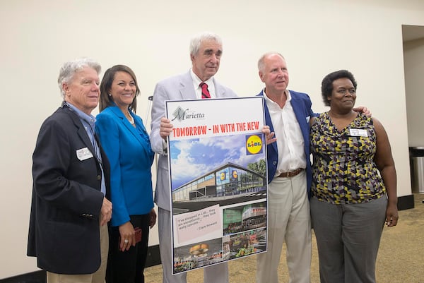 Marietta Mayor Steve Tumlin (center) poses for a photo with Marietta City Council members Griffin L. Chalfant (left), Michelle Cooper Kelly (second fro left), Johnny Walker (second from right) and Cheryl Richardson (right) following the state of the city address at the Mansour Conference Center in Marietta, Wednesday, May 15, 2019. During the meeting it was revealed that the city would be getting a LIDL grocery store. (Alyssa Pointer/alyssa.pointer@ajc.com)