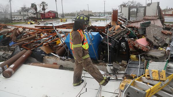 ROCKPORT, TX - AUGUST 26:  A Rockport firefighter goes door to door on a search and rescue mission as he looks for people that may need help after Hurricane Harvey passed through on August 26, 2017 in Rockport, Texas. Harvey made landfall shortly after 11 p.m. Friday, just north of Port Aransas as a Category 4 storm and is being reported as the strongest hurricane to hit the United States since Wilma in 2005. Forecasts call for as much as 30 inches of rain to fall in the next few days. (Photo by Joe Raedle/Getty Images)