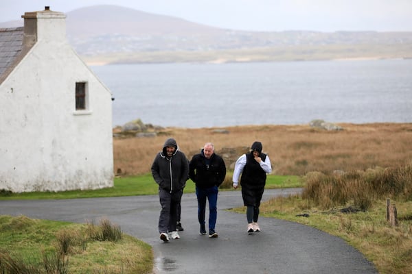 Island residents walk to a polling station on the Island of Gola as voters go to polls the for the 2024 General Election in Ireland, Friday, Nov. 29, 2024. (AP Photo/Peter Morrison)