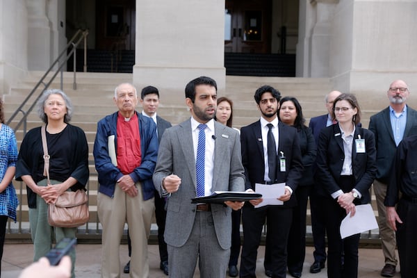 Surrounded by several groups, Murtaza Khwaja, executive director of the Georgia chapter of the Council on American-Islamic Relations (CAIR), speaks at a news conference Monday, March 27. They oppose House Bill 144, also known as the antisemitism bill. (Natrice Miller/The Atlanta Journal-Constitution)