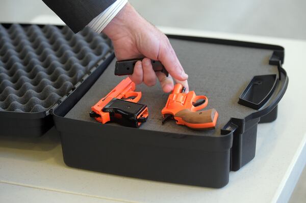 Mark Howell, TSA Regional Spokesman, demonstrates the proper way to travel with firearms during a TSA event at Hartsfield-Jackson International Airport Friday, July 31, 2015. KENT D. JOHNSON / AJC