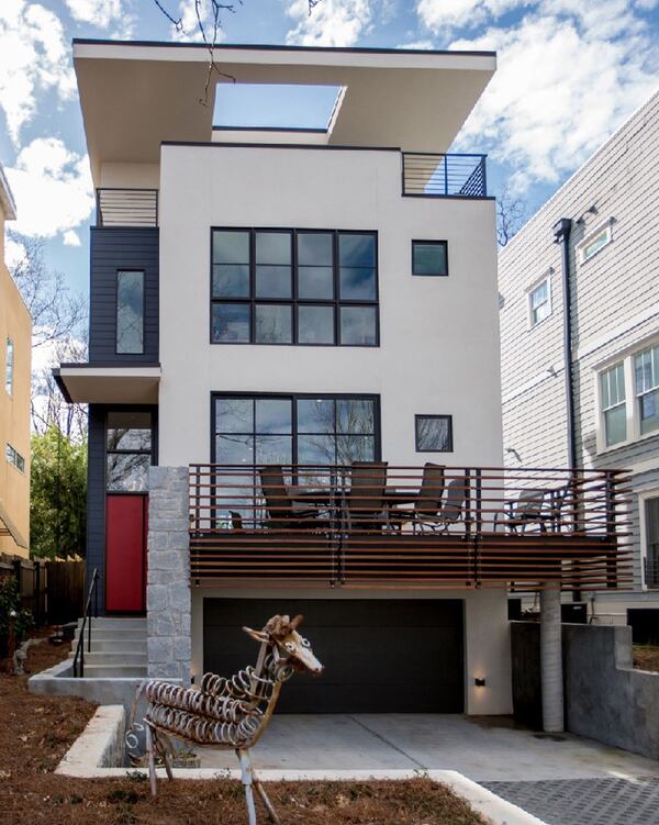 With views of the city, this four-level home was designed by Atlanta-based TaC Studios for empty nesters in the Old Fourth Ward. An elevator services the garage level to the roof terrace, allowing the owners to age in place. The living room, kitchen, office, powder room and dining area are on the second level of this 3,000-square-foot home. The master bedroom suite, guest bedroom, bath and artist studio (or third bedroom) are on the third level. The roof level has terraces on the north and south sides. CONTRIBUTED BY MICHAEL TAVEL