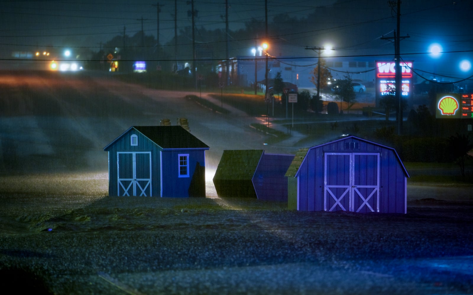 Three sheds sit in the middle of North Marrietta Parkway. Floodwaters engulfed multiple roads in Cobb county early Wednesday morning. Ben Hendren for the AJC