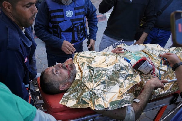 An injured United Nations Mine Action Service (UNMAS) worker is brought into al-Aqsa Martyrs Hospital following what the U.N. described as a strike in which an explosive ordnance was "dropped or fired" in Deir al-Balah, central Gaza, Wednesday, March 19, 2025. (AP Photo/Abdel Kareem Hana)