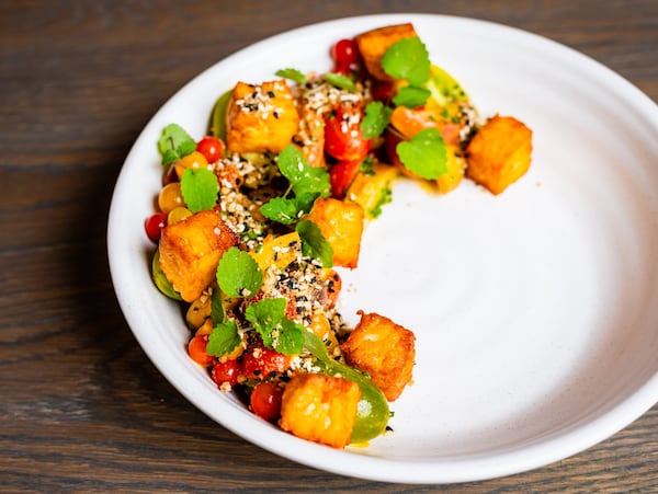 The halloumi salad at Aziza pairs cubes of grilled cheese — golden outside, melty inside — with peach slices and tomatoes of all colors, shapes and sizes. CONTRIBUTED BY HENRI HOLLIS