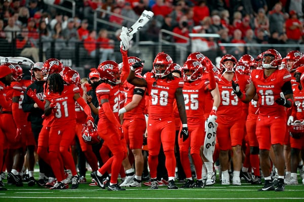 UNLV cheer during a timeout during the second half of an NCAA college football game against Nevada Saturday, Nov. 30, 2024, in Las Vegas. (AP Photo/David Becker)