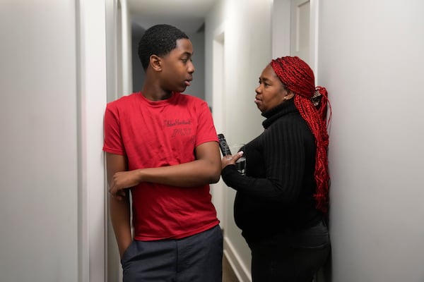 Zuleika, right, and her son Josafat, 14, immigrants from Central America seeking asylum, speak together at their home Thursday, Feb. 20, 2025, in Chicago. (AP Photo/Erin Hooley)