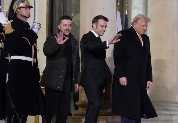 French President Emmanuel Macron, center, President-elect Donald Trump, right, and Ukraine's President Volodymyr Zelenskyy leave after their meeting at the Elysee Palace, Saturday, Dec. 7, 2024 in Paris. (AP Photo/Michel Euler)