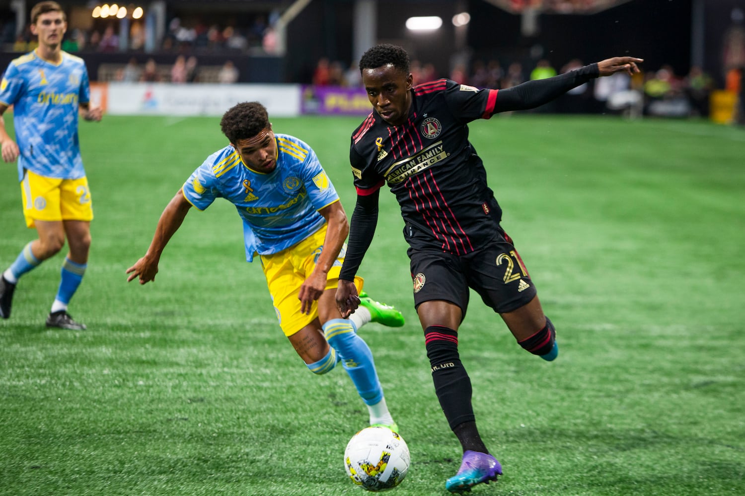 Edwin Mosquera, forward for Atlanta United, dribbles the ball under pressure from Philadelphia Union fullback Nathan Harriel. CHRISTINA MATACOTTA FOR THE ATLANTA JOURNAL-CONSTITUTION.