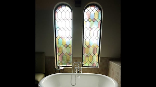 Stained glass windows frame a deep tub that's just right for a relaxing soak in a treatment room at The Spa at the Cloister, a sister property of the Lodge. The room is also used for facials, massages and other treatments.