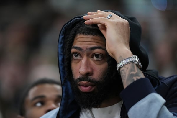 Dallas Mavericks forward Anthony Davis watches from the bench during the second half of an NBA basketball game against the San Antonio Spurs in San Antonio, Monday, March 10, 2025. (AP Photo/Eric Gay)