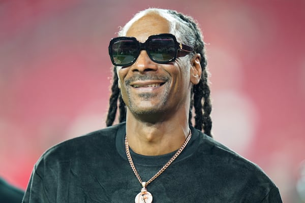 FILE - Entertainer Snoop Dogg walks on the field before an NFL football game between the Tampa Bay Buccaneers and the New Orleans Saints on Dec. 19, 2021, in Tampa, Fla. (AP Photo/Chris O'Meara, File)