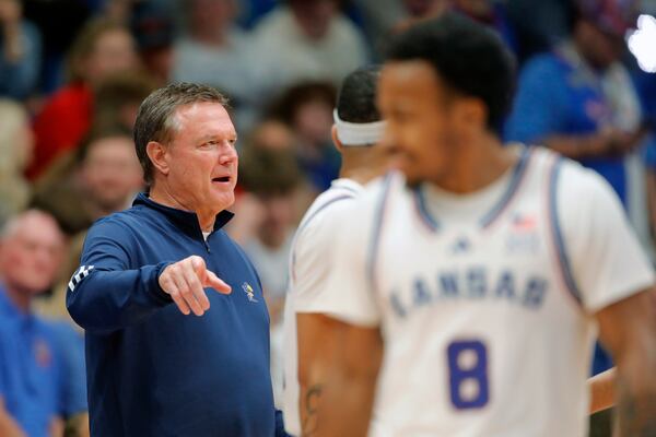 Kansas head coach Bill Self, left, speaks with his players during the second half of an NCAA college basketball game against Howard, Monday, Nov. 4, 2024, in Lawrence, Kan. (AP Photo/Colin E. Braley)