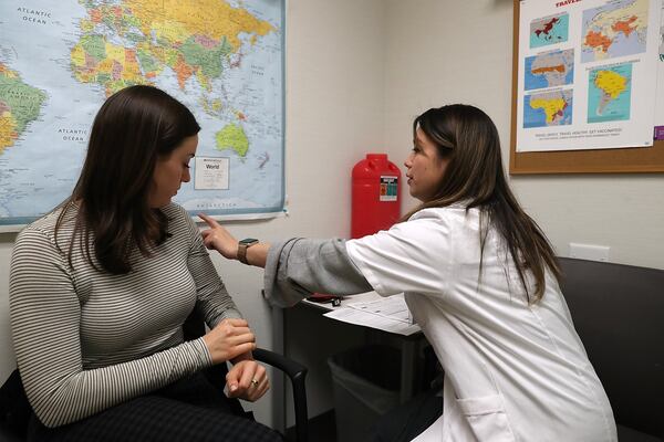 Shown here, Simone Groper prepares to receive a flu shot this season at a Walgreens pharmacy in San Francisco. (PHOTO by Justin Sullivan/Getty Images)